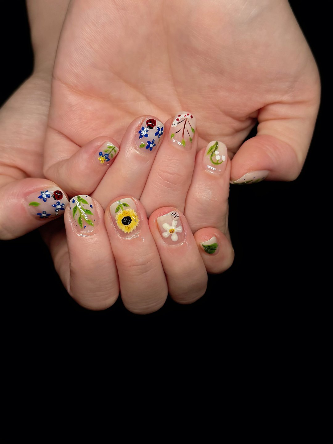 Mismatched mini-art Gel-X with sunflower, bow and pressed-flower designs at L2 Nail Salon Mountain View