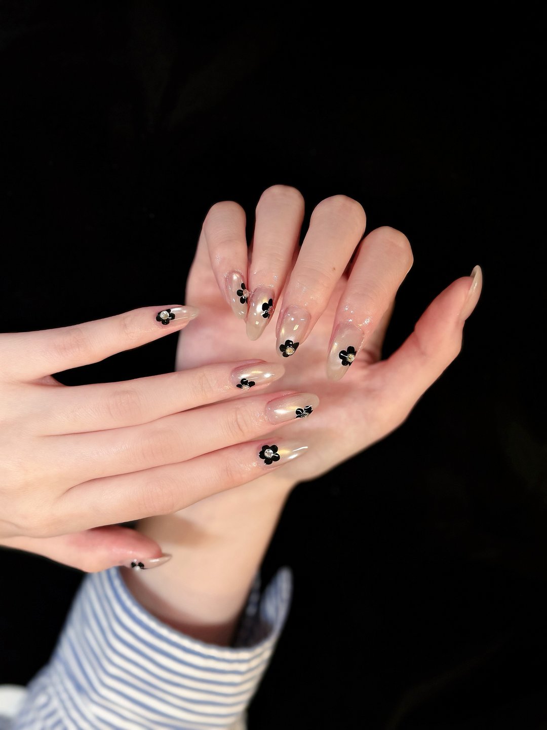 Hand-painted daisy art on bare almond at L2 Nail Salon Mountain View