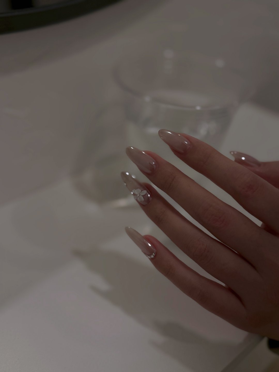 Pearl neutral Gel-X with floral charm accent at L2 Nail Salon Mountain View